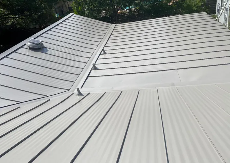 Solar attic fan installed on a metal roof for Roof Ventilation in Lake Forest Park
